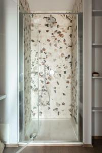 um chuveiro com uma porta de vidro na casa de banho em Riviera Views Apartment by Welc(H)ome em Treviso