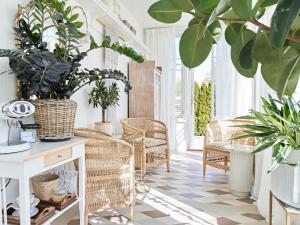 a room with plants and a table and chairs at Hans Hubert Villa in Haapsalu