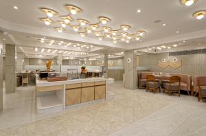 a lobby with a kitchen and a dining room at Exora Inn in Ahmedabad