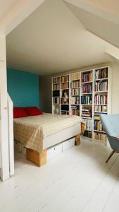 a bedroom with a bed and book shelves at ApartmentInCopenhagen Apartment 1594 in Copenhagen