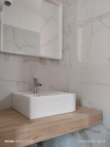 a bathroom with a white sink and a mirror at Hotel Aldebaran in Rimini