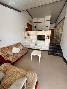 a living room with a couch and a table at Chalet con piscina privada en Calles in Calles