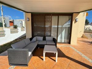 a couch and a table on a patio at Chalet con piscina privada en Calles in Calles