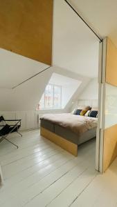 a bedroom with a bed and a large window at ApartmentInCopenhagen Apartment 1594 in Copenhagen