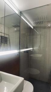 uma casa de banho com uma cabina de duche em vidro e um lavatório. em ApartmentInCopenhagen Apartment 1594 em Copenhague