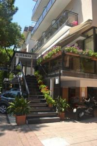 a building with stairs and plants in front of it at Hotel Aldebaran in Rimini