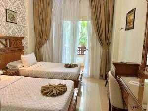 A bed or beds in a room at Teba Hotel Ras Elbar