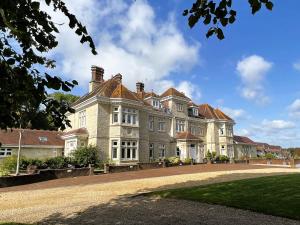 a large house with a driveway in front of it at 2 Shanklin Manor - Ground Floor apartment overlooking Park in Shanklin Old Village in Shanklin