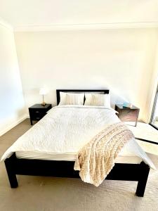 a bedroom with a large bed with a white comforter at Fully Equipped 3BR-Townhouse in Northfield