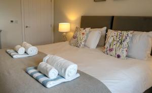 a bed with towels and pillows on it at Pippin in Spilsby