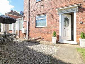 a brick house with a table and an umbrella at Cedar Street in Chesterfield