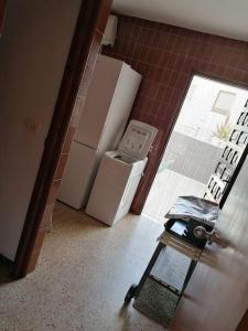 a small kitchen with two refrigerators and a window at Casa Gares in Peñíscola +11 photos