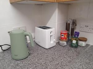 a white toaster sitting on a counter with spices at Dean Edge in Cinderford