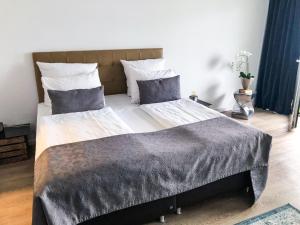 a bedroom with a large bed with two pillows at Rheinblick Apartments in Cologne