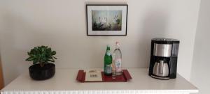 a counter with a coffee maker and two bottles of wine at SOHL FARM in Neutrebbin