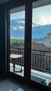 a view from a balcony with a table and a view at Tirta Kemala House in Ubud