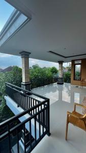 a house with a balcony with a view of the mountains at Tirta Kemala House in Ubud