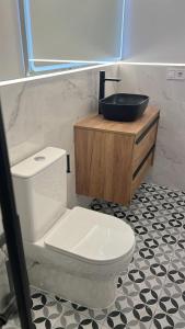 Un baño con un inodoro blanco y un lavabo. en Apartamentos Marqués, en Alicante