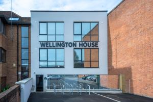 een gebouw met een bord dat Wellington House leest bij Wellington House by Celador Apartments in Reading