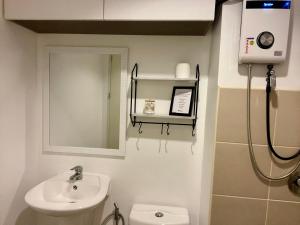 a bathroom with a sink and a toilet at A city escape at the Avida Towers Aspira 1 in Cagayan de Oro +22 photos