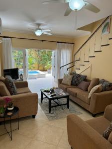 a living room with two couches and a table at Westland villa's in Saint James