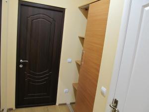 a dark wooden door in a room with stairs at Mini-hotel Na Pidgradskiy in Uzhhorod