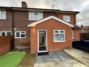 a red brick house with a front door at 2nd Studio Flat With Great Views in Keedonwood Road With Private Kitchenette and shared bathroom in Bromley