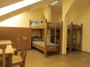 two bunk beds in a room with a table at Mini-hotel Na Pidgradskiy in Uzhhorod