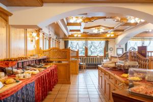 a large kitchen with a lot of food on the counters at Sport Hotel Cristal in Falcade
