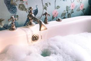 a sink with water coming out of a faucet at The Portobello Hotel in London