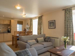 a living room with a couch and a table at St Brides View Solva in Solva