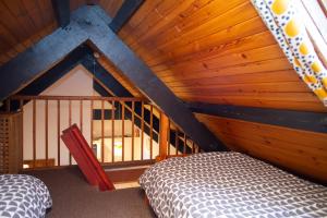 a bedroom with a bed and a wooden ceiling at Bay Cottage Little Haven in Little Haven