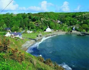 a view of a body of water with houses and trees at Orielton Newport in Dinas