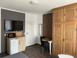 a small room with a kitchen with a table and a door at Apartments-Bocholt in Bocholt