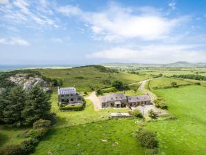 an aerial view of a house on a hill with the ocean at Cnwc Y Bran St Nicholas in Saint Nicholas