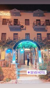 a man standing in front of a building at Sevgi Hotel Kalkan in Kalkan