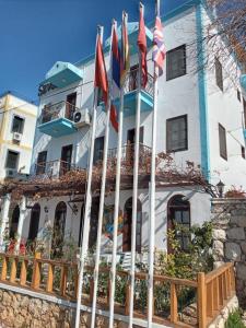 a building with flags in front of it at Sevgi Hotel Kalkan in Kalkan
