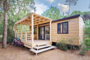 a tiny house with bikes parked in front of it at PuntAla Camp & Resort in Punta Ala