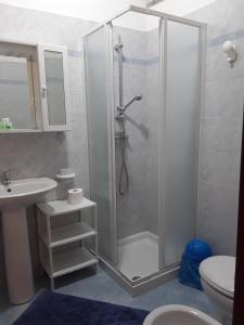 a bathroom with a shower with a sink and a toilet at Il Fenicottero Elmas in Elmas