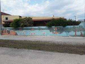 a wall with a mural of flamingos on it at Il Fenicottero Elmas in Elmas