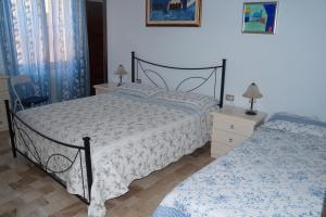 a bedroom with a bed and two nightstands and a bed sidx sidx sidx at Il Fenicottero Elmas in Elmas