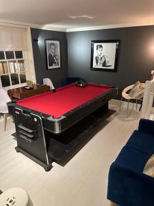 a room with a pool table in the middle of a room at Stylish Georgian Townhouse, Yorkshire - sleeps 12 in Easingwold