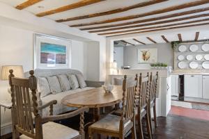 a kitchen and living room with a table and chairs at North End House - Batheaston in Bath