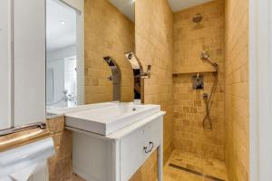 a bathroom with a white sink and a shower at North End House and Seven Acres Cottage in Batheaston