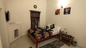 a bedroom with a bed with a stuffed animal on it at BOB's Haven Bungalow in Ooty