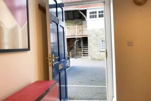 an open door with a view of a courtyard at Central Shaftesbury with private parking in Shaftesbury