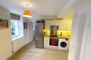 a kitchen with a stainless steel refrigerator and a dishwasher at Central Shaftesbury with private parking in Shaftesbury +14 photos