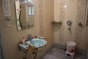 a bathroom with a sink and a mirror at SWET APARAJITA in Bolpur