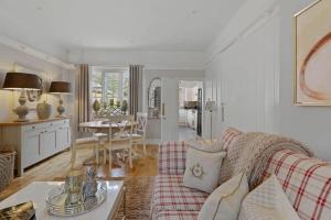 a living room with a couch and a table at Rosemary Cottage in Leicester