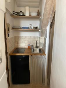 a small kitchen with a sink and a counter at Le Mini - Un voyage en Provence in Aix-en-Provence